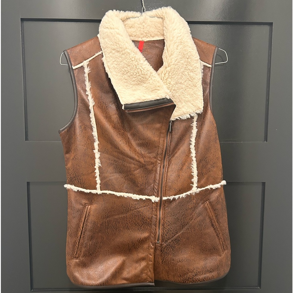 Polyester faux fur vest. No tags but has never been worn. Good as new.